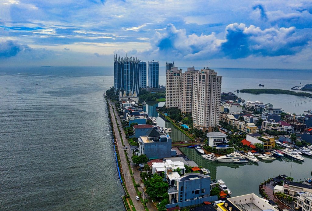 drone shot of buildings near the sea